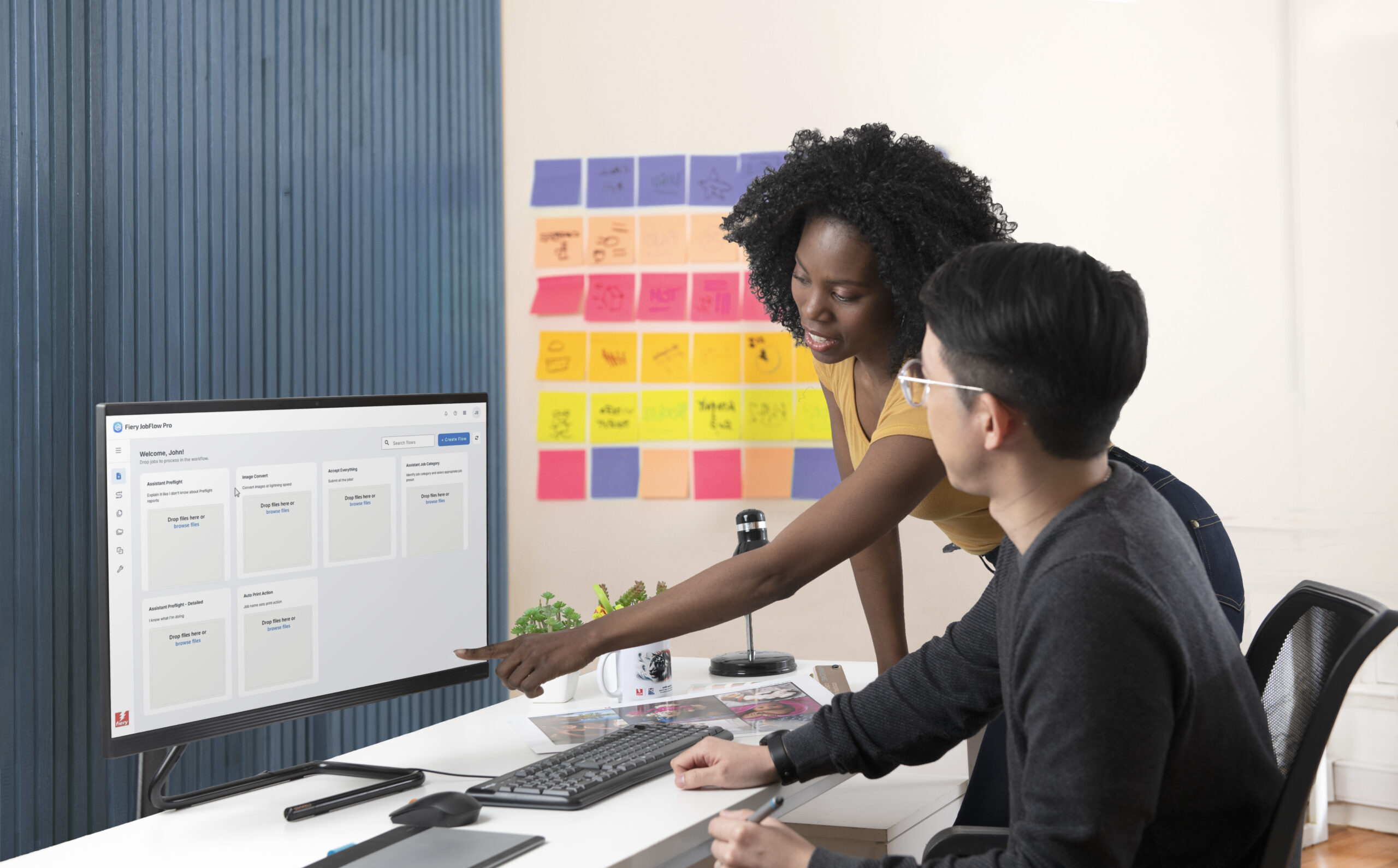 Operators looking at Fiery JobFlow Pro on screen 2